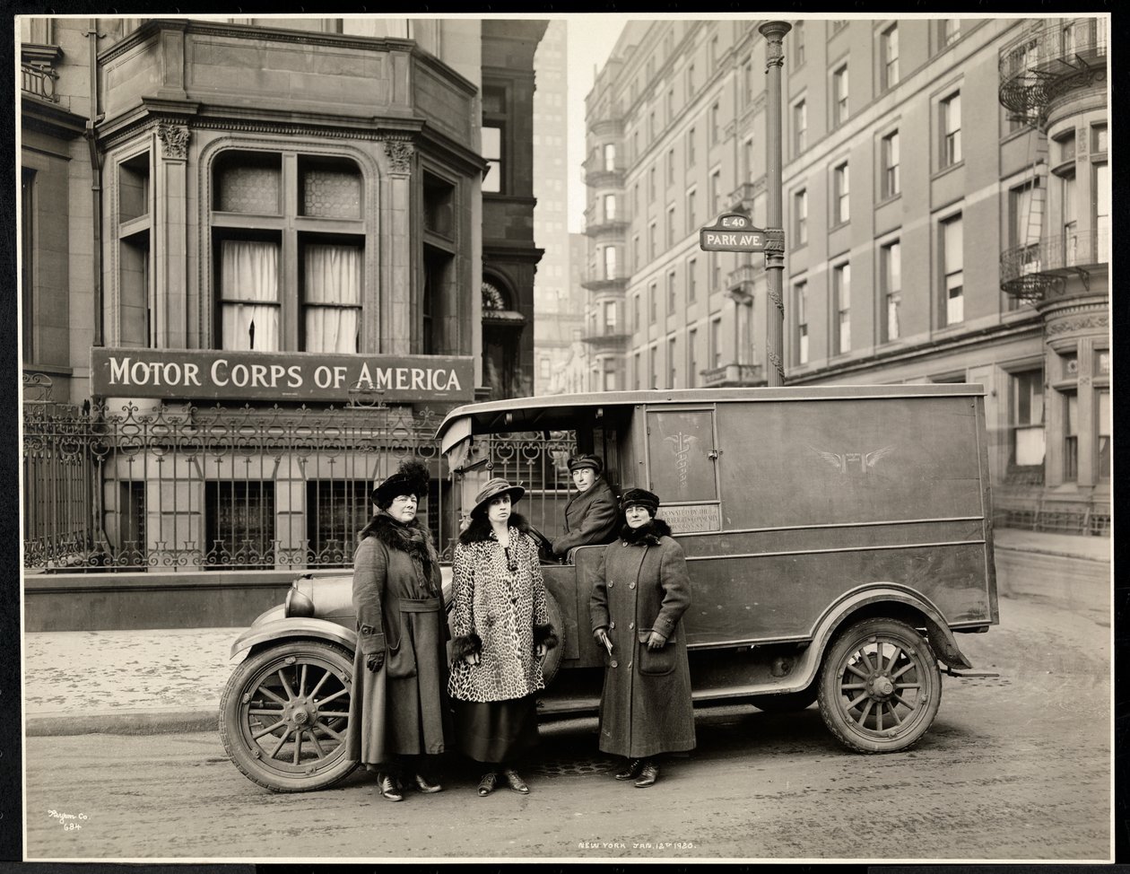 Cztery kobiety z Motor Corps of America stoją przed karetką (jedna kobieta na siedzeniu kierowcy) na Park Avenue przy 40th Street przed budynkiem Motor Corps of America, Nowy Jork, 1920 r. autorstwa Byron Company